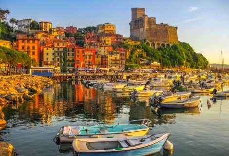 Lerici , Italy- June 5, 2010: Boats of Lerici docked in Lerici port and famous Italian Gulf of Poets. San Giorgio castle on the background at sunset. La Spezia province, Ligurian Coast of Italy.